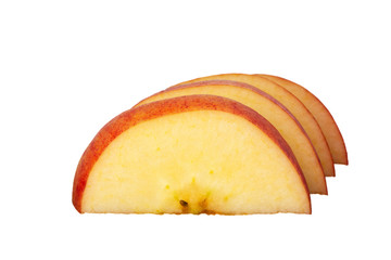 Close up of a sliced red apple on a wooden plate with isolated background.
