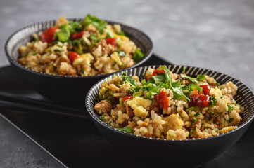 Thai pork rice with fried eggs and cilantro.