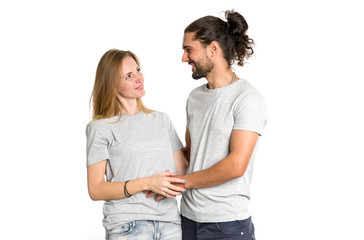 Portrait of happy couple on white background. Couple in love, man and woman hugging and look at each other.