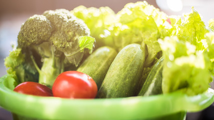 Healthy Food. There are vegetables, cucumbers, tomatoes and broccoli in the sieve for cleaning.