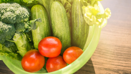 Healthy Food. There are vegetables, cucumbers, tomatoes and broccoli in the sieve for cleaning.