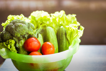 Healthy Food. There are vegetables, cucumbers, tomatoes and broccoli in the sieve for cleaning.