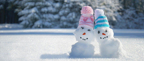 zwei Schneemänner im Winterwald