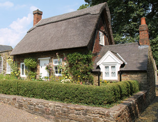 Fototapeta na wymiar A Classic English Village Residential Thatched Cottage.