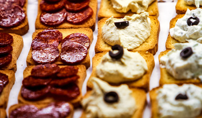 Decorated catering banquet table with different  tapas food snacks and appetizers