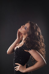 Fototapeta premium Portrait of a young attractive woman with gorgeous curly hair. Attractive brunette.