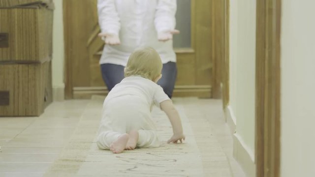 Baby crawling to his mother