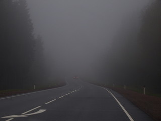 Empty road in heavy fog
