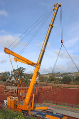 Crane lifting a bridge beam