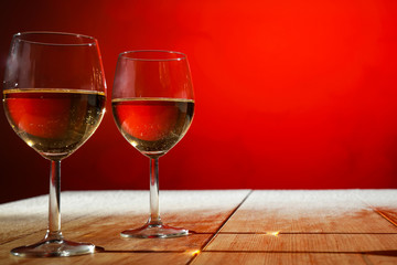 Two glasses with white wine on an old wooden table in a Christmas mood  