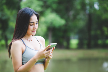 Fitness asian woman doing yoga in park