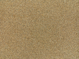Fototapeta na wymiar beige plain grained sand, gravel or grit surface texture