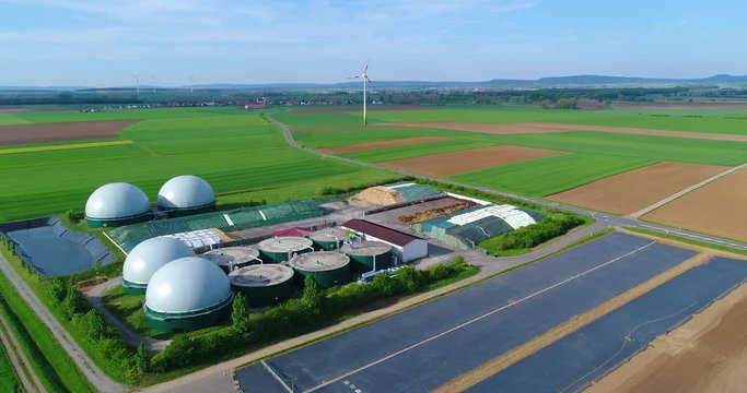Aerial video of Biogas plant. Flight over Biogas power plants, The agricultural and greenhouse complex is equipped with its own biogas for the production of biogas, Europe