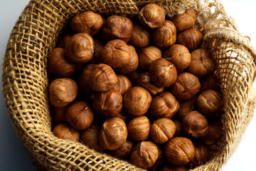A handful of raw hazelnuts in textile bag. Overhead image