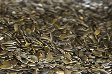 peeled pumpkin seeds green background selective focus