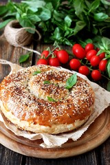 Flaky pastry filled with chicken meat and onions with cherry tomatoes and basil