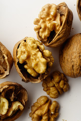 Raw walnuts with cracked nutshells on white background isolated