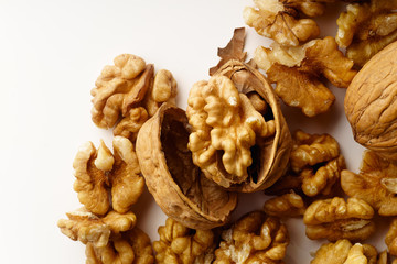 A heap of raw walnuts on white background isolated with copy space