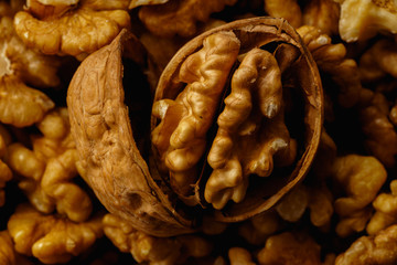 Obraz premium Raw walnut with cracked nutshells. Macro shot with central composition