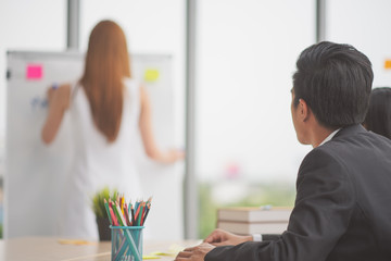 Successful business young woman presenting to employees, business coach giving presentation to clients in meeting room, team leader reporting about work explaining result on whiteboard