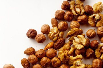 Overhead image of assorted nuts on white background with copy space