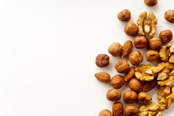 Overhead image of assorted nuts on white background with copy space