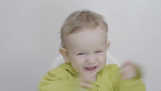 Portrait of child laughing and moving hands, happy child