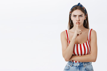 Shut up now. Irritated serious-looking bossy attractive woman in striped summer top and headband...