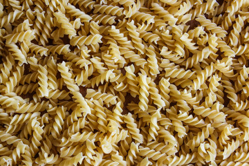 Uncooked fusilli pasta background