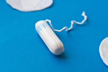 Woman hygiene protection. Cotton tampons on blue background