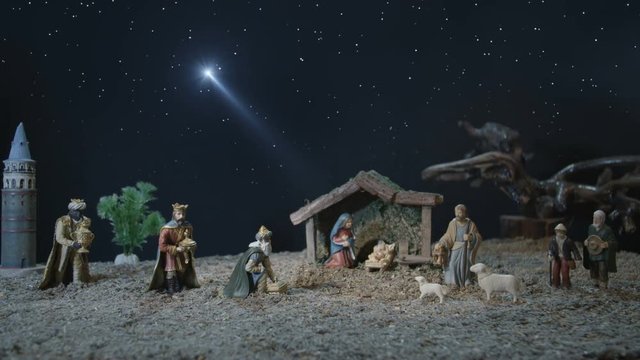 Nativity scene with figurines in the manger including baby Jesus, Mary, Joseph, shepherds, three wise men and the Christmas star.