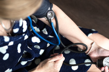 woman measures her blood pressure