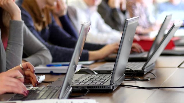 Participants using laptops during educational business conference