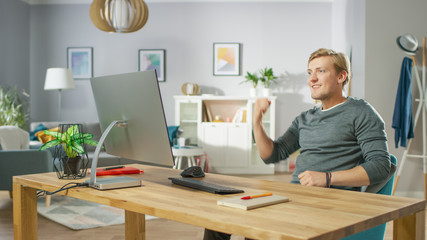 Portrait of the Handsome Man Working on Personal Computer Has Stroke of Luck, Emotionally...