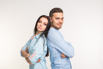 Relationship and people concept - Couple posing back to back on white background