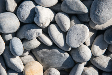 Smooth grey pebbles on a beach