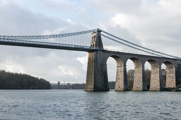A view of the historic Menai suspension bridge spanning the Menai Straits, Gwynnedd, Wales, UK.