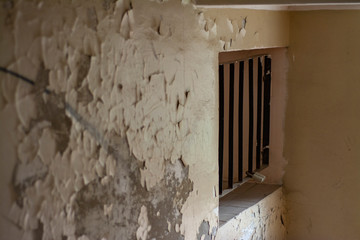 Barred window at the entrance of an old Soviet-built house in Eastern Europe