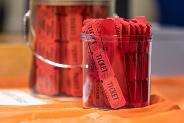 Red raffle tickets in  jar