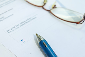 Fototapeta premium Financial paperwork for signature concept on blank white paper. Empty document to sign.