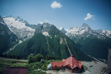 Fototapeta na wymiar Caucasus mountain range in summer, snow-capped peaks, Sunny day, tent in the foreground