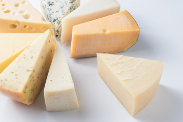 Different kinds of cheeses isolated on white background.