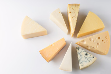 Different kinds of cheeses isolated on white background.