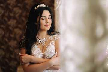 Beautiful bride in wedding dress. brunette woman posing to photographer