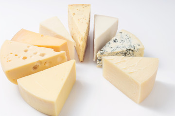 Different kinds of cheeses isolated on white background.