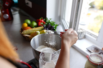 Photo of young pretty lady standing in kitchen