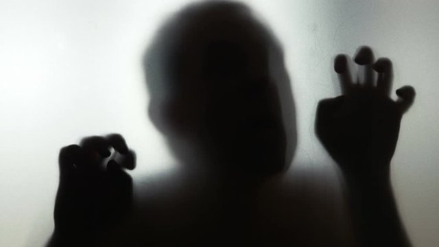 Scary human behind frosted glass in 4k slow motion 60fps
