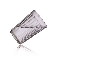 Faceted glass with a drink is tilted