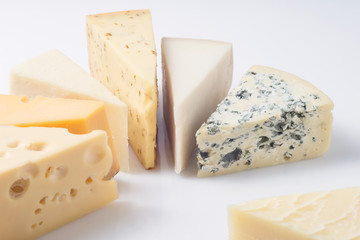 Different kinds of cheeses isolated on white background.