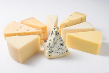 Different kinds of cheeses isolated on white background.